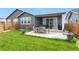 Expansive backyard featuring a patio, dining space, lush green grass, and a charming fence at 23936 E River Front Dr, Aurora, CO 80019