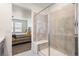 Bathroom with view of shower with bench seat and tiled walls in addition to view into bedroom at 23936 E River Front Dr, Aurora, CO 80019