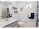 Well-lit bathroom with a sleek vanity, decorative shelves, and modern fixtures at 23936 E River Front Dr, Aurora, CO 80019