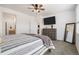 Bedroom with TV, dresser, full-length mirror and adjoining bathroom view provides great space and functionality at 23936 E River Front Dr, Aurora, CO 80019
