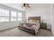 Bright bedroom featuring a ceiling fan, carpet flooring, and three large windows providing natural light at 23936 E River Front Dr, Aurora, CO 80019