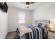Cozy bedroom with a modern ceiling fan, large window, and stylishly appointed bed at 23936 E River Front Dr, Aurora, CO 80019