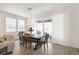 Bright dining room with natural light, a stylish chandelier, and access to the outdoor patio at 23936 E River Front Dr, Aurora, CO 80019