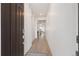 Inviting hallway with light wood floors and neutral white walls leading to other rooms in the house at 23936 E River Front Dr, Aurora, CO 80019