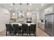 Stylish kitchen featuring white countertops, a central island with bar seating, and gray cabinetry at 23936 E River Front Dr, Aurora, CO 80019