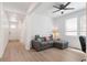 Comfortable living room featuring a gray couch and a large window, creating a warm and inviting atmosphere at 23936 E River Front Dr, Aurora, CO 80019