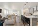 Open-concept living area with a view of the kitchen and dining space, creating a cohesive flow at 23936 E River Front Dr, Aurora, CO 80019