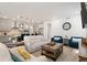 Spacious living room showcases an open floor plan with a modern kitchen in the background at 23936 E River Front Dr, Aurora, CO 80019