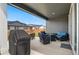 Covered patio with an outdoor seating area, grill, and a view of the fenced backyard, great for entertaining at 23936 E River Front Dr, Aurora, CO 80019