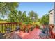 Cozy red back deck with iron furniture and potted plants offering a relaxing outdoor space at 15649 E 7Th Cir, Aurora, CO 80011