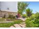 Landscaped backyard with stone patio and views of the surrounding greenery at 15649 E 7Th Cir, Aurora, CO 80011