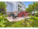 Backyard with stone patio, seating, a grill, and stairs to the deck at 15649 E 7Th Cir, Aurora, CO 80011