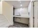 Unfinished basement area featuring a sink, utility connections, and gray tile flooring at 15649 E 7Th Cir, Aurora, CO 80011