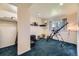Finished basement with blue carpet, shelving, and a window providing natural light at 15649 E 7Th Cir, Aurora, CO 80011