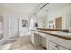 Well-lit bathroom featuring double sinks, a soaking tub, and neutral-toned tile flooring for a clean and inviting space at 15649 E 7Th Cir, Aurora, CO 80011