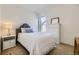 Cozy bedroom featuring a floral-patterned headboard, white dresser, and soft natural light, creating a relaxing ambiance at 15649 E 7Th Cir, Aurora, CO 80011