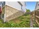 Stone foundation with garden beds at the base of home's exterior wall at 15649 E 7Th Cir, Aurora, CO 80011