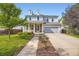 Charming two-story home with stone accents, a well-manicured lawn, and a welcoming front porch at 15649 E 7Th Cir, Aurora, CO 80011