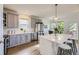 Bright kitchen featuring stainless steel appliances, gray cabinets, and a large center island with seating at 15649 E 7Th Cir, Aurora, CO 80011