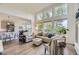 Spacious living room with high ceilings, large windows, and hardwood floors offering abundant natural light at 15649 E 7Th Cir, Aurora, CO 80011