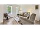 Comfortable living room with hardwood floors, large windows, and neutral decor providing a relaxing atmosphere at 15649 E 7Th Cir, Aurora, CO 80011