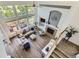 Open living area with a cozy fireplace, soaring windows, hardwood floors, and comfortable seating at 15649 E 7Th Cir, Aurora, CO 80011