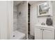 Modern shower room featuring a walk-in shower with gray tiles, a sleek vanity, and minimalist design at 15649 E 7Th Cir, Aurora, CO 80011