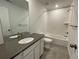 Bathroom with white cabinets, subway tile, and a bathtub at 585 Twilight St, Erie, CO 80516