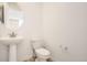 Compact bathroom showcasing pedestal sink and modern toilet at 585 Twilight St, Erie, CO 80516