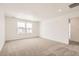 Bright bedroom features neutral carpet, white walls, and natural light from two windows at 585 Twilight St, Erie, CO 80516