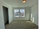 Bedroom with natural light, a closet, neutral carpet, and fresh, white paint at 585 Twilight St, Erie, CO 80516