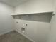 Laundry room with shelving and hookups for washer and dryer at 585 Twilight St, Erie, CO 80516