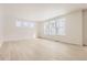 Bright living room featuring big windows and light colored wood flooring at 585 Twilight St, Erie, CO 80516