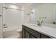 Modern bathroom featuring a tub, shower, and dark vanity with a white countertop at 1785 Grayside Cir, Castle Rock, CO 80109