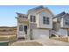 Charming modern farmhouse featuring stone accents, bright white siding, and a two-car garage at 1785 Grayside Cir, Castle Rock, CO 80109