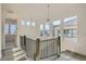 Open hallway with wood floors, staircase, and large windows showcasing the neighborhood at 1785 Grayside Cir, Castle Rock, CO 80109