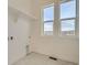 Bright laundry room with tile flooring, shelving, and large windows overlooking a scenic view at 1785 Grayside Cir, Castle Rock, CO 80109