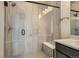 Modern shower features glass door, shower bench, rainfall shower head and tile surround at 1785 Grayside Cir, Castle Rock, CO 80109