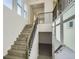 Open staircase with modern railings, leading to the upper and lower levels of the home at 1785 Grayside Cir, Castle Rock, CO 80109