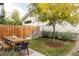 Backyard with wooden table and chairs, tree, and a staircase, perfect for outdoor relaxation at 3422 S Grant St, Englewood, CO 80113