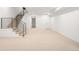 Large basement with neutral carpeting, a staircase, and white walls offers plenty of space at 3422 S Grant St, Englewood, CO 80113