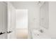 Bright bathroom with white fixtures and a light-filled doorway offers a clean and airy aesthetic at 3422 S Grant St, Englewood, CO 80113