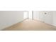 Neutral carpeted bedroom shows a window, doorway and two closed white doors at 3422 S Grant St, Englewood, CO 80113