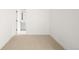 Bright bedroom with neutral carpet features a white door to the bathroom at 3422 S Grant St, Englewood, CO 80113