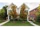 Modern home featuring white siding, wood accents, well-manicured lawn, and fresh landscaping at 3422 S Grant St, Englewood, CO 80113
