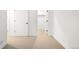 Hallway featuring white walls, neutral carpet, and minimalist trim and doors at 3422 S Grant St, Englewood, CO 80113