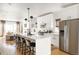 Modern kitchen with a center island, breakfast bar, stainless steel appliances, and bright living area at 3422 S Grant St, Englewood, CO 80113