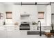 Bright kitchen with modern appliances, white countertops, and a stainless steel range hood at 3422 S Grant St, Englewood, CO 80113