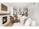 Spacious open-concept living area showcasing the kitchen, staircase, and fireplace at 3422 S Grant St, Englewood, CO 80113