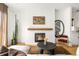 Inviting living room with a fireplace, wood mantel, stylish decor, and wood flooring at 3422 S Grant St, Englewood, CO 80113